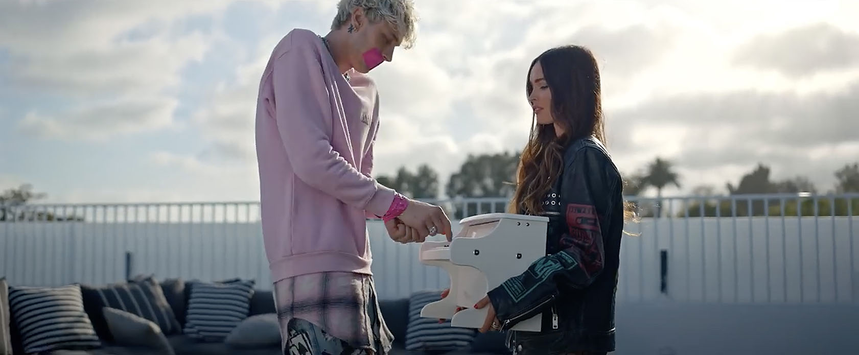 Megan Fox and Machine Gun Kelly playing tiny piano in video for the song Bloody Valentine