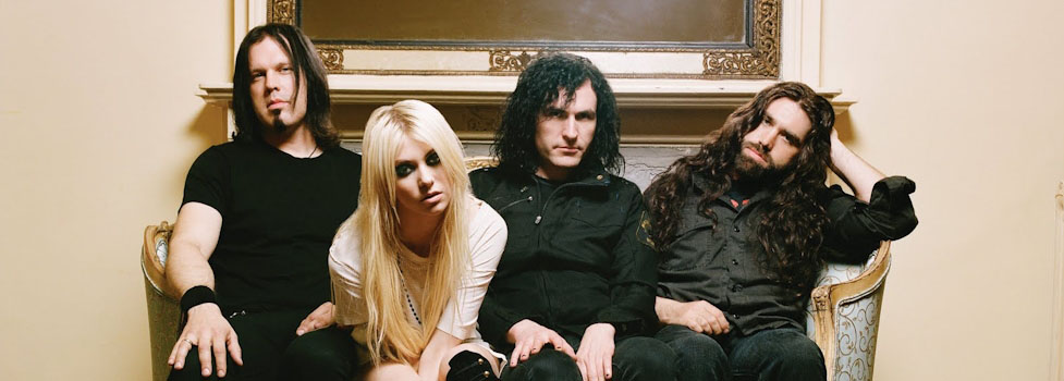 The Pretty Reckless band on a sofa